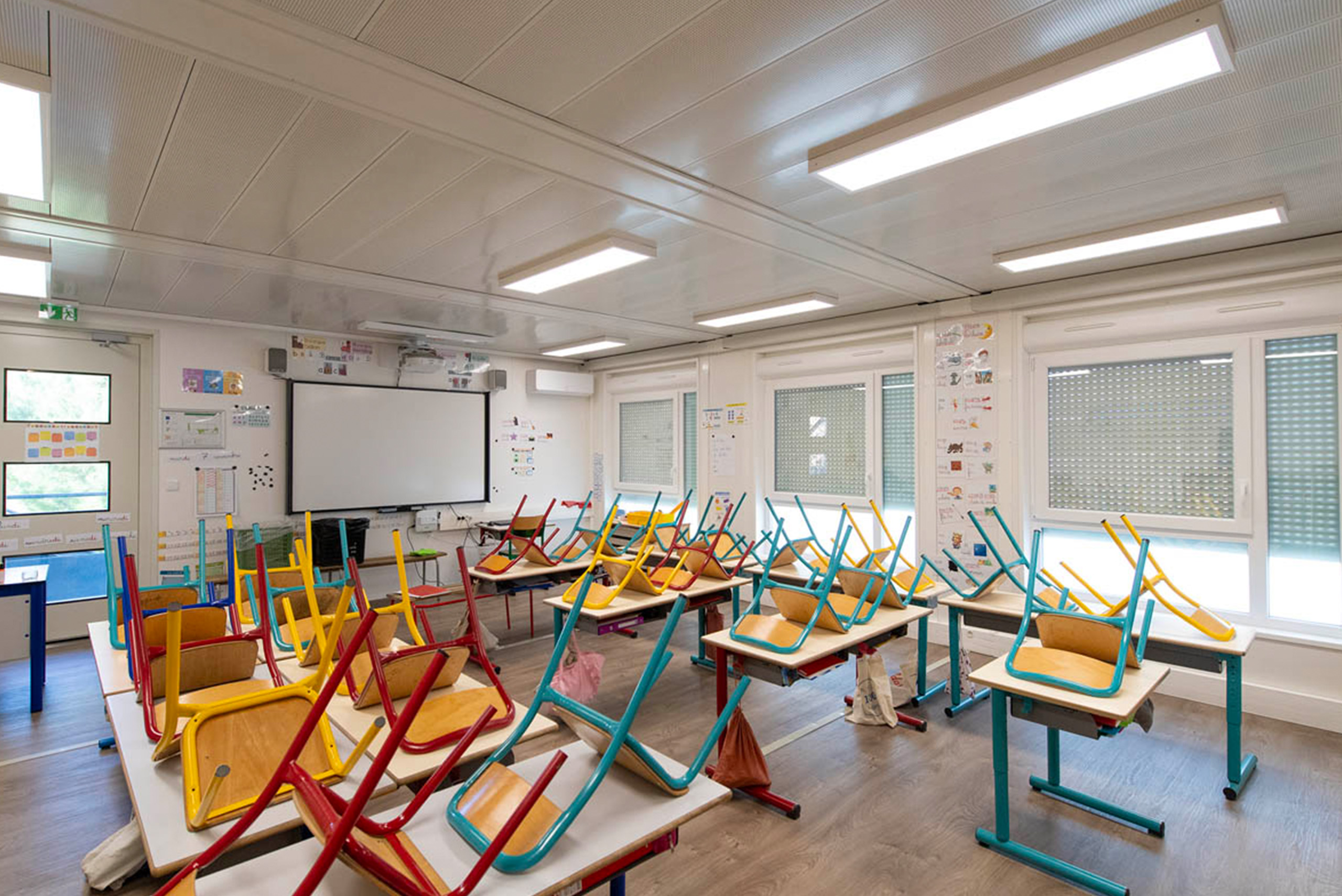Salle de classe modulaire ALGECO® avec chaises rangées sur les tables