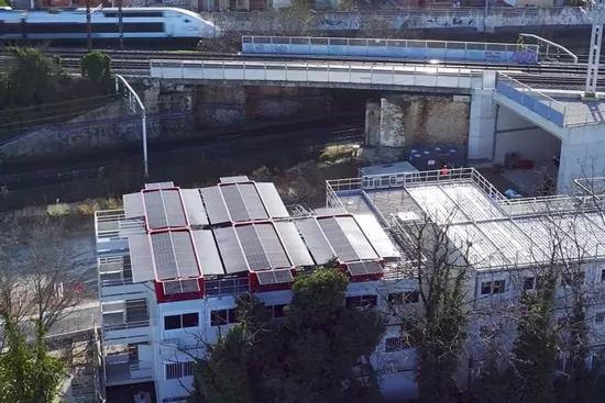 Vue aérienne d’un toit modulaire équipé du système SOLAR 4.0 d’Altempo avec panneaux photovoltaïques près d’une voie ferrée