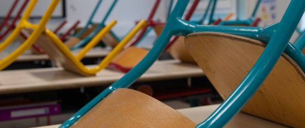 Salle de classe modulaire ALGECO® avec chaises retournées sur les bureaux