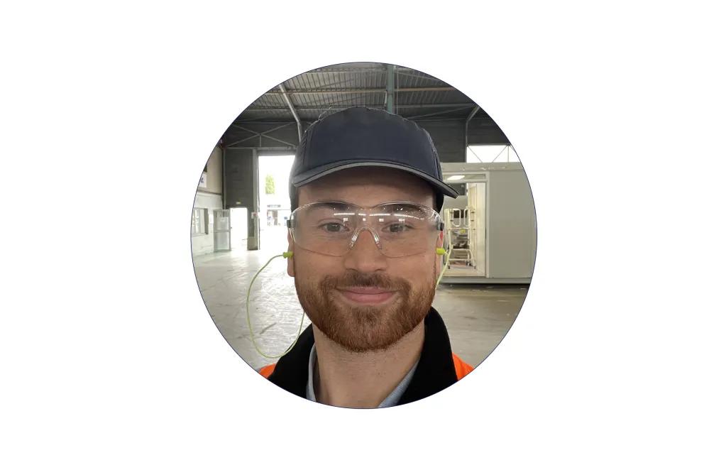  Thomas Despagnot équipé de lunettes de protection et gilet haute visibilité dans un atelier industriel