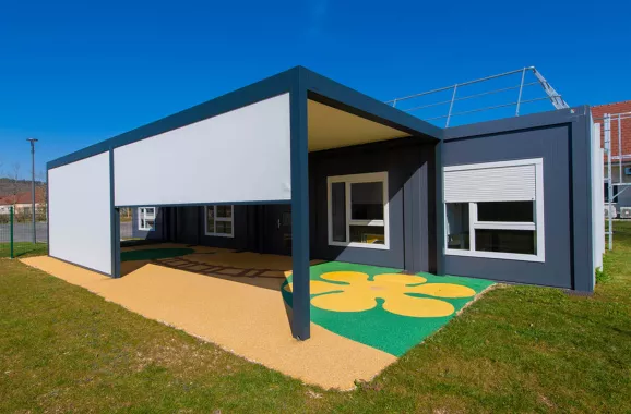 Façade extérieure de la crèche modulaire ALGECO® « Les libellules du Suzon » à Messigny-et-Vantoux avec pergola et sol coloré